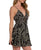 A model wearing a black and green leaf patterned mini dress with a lace-up front and tiered skirt.