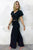 Woman wearing a black outfit against a white background